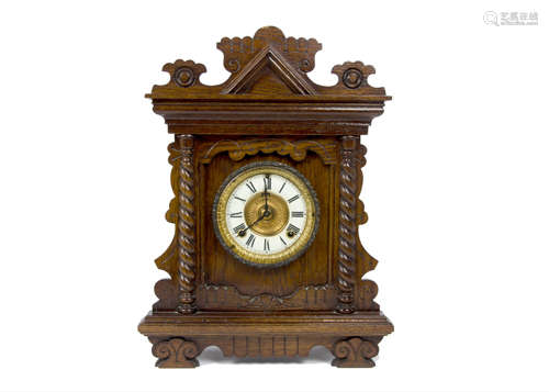 A late 19th Century American oak cased Gingerbread mantle clock by Ansonia Clock Company, New