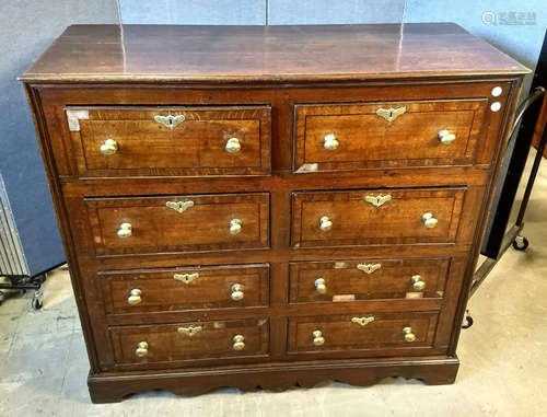 A late 18th Century oak and ebonised strung chest, eight short drawers, brass pulls, shaped plinth