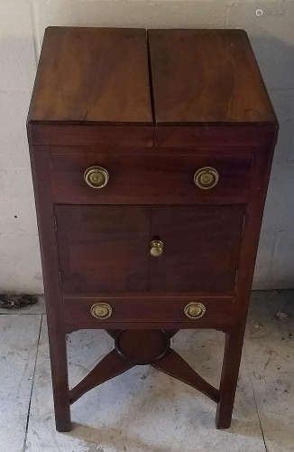 A Georgian mahogany and boxwood strung enclosed wash stand, double hinged top, two panel doors above