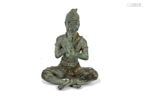 A 20th Century Thai bronze of Phra Aphai Mani crosslegged, playing his magic flute, 15 cm high
