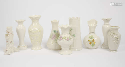 A collection of Belleek porcelain vases, including a naturalistic 1st period tree spill vase, an