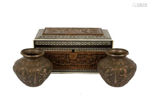 A Middle Eastern wood and ivory inlaid box, hinged lid, carved relief decoration of animals and