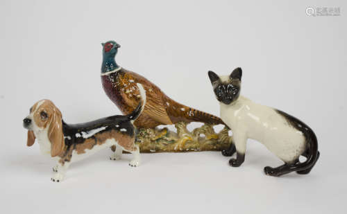 Three Beswick animal studies, including a Siamese cat no 1897, a basset hound no 2045 and a pheasant