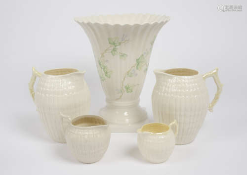A group of Belleek porcelain, including a 3rd period milk jug, a ribbed flared vase on square base