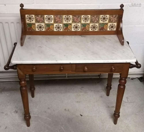 A 19th Century mahogany and marble topped wash stand, mahogany and tiled splash back with finials,