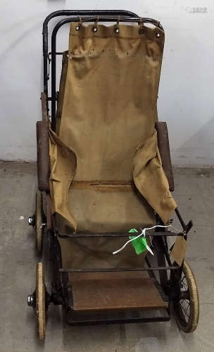 A early 20th Century Richards adjustable wheelchair, canvas covers on tubular metal frame (af)