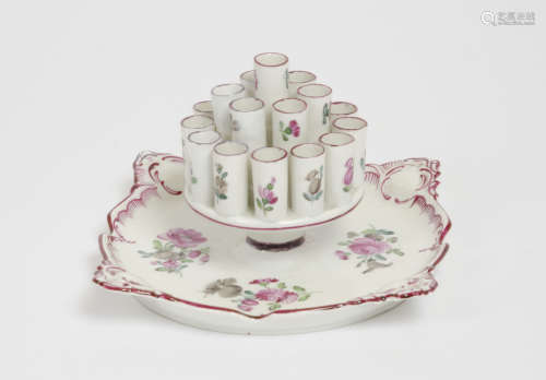 A late 19th Century porcelain cigarette holder, decorated with flowering shrubs within a pink