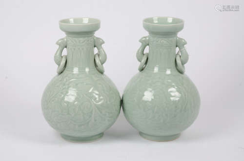 A pair of Chinese celadon glazed lamp bases, loop and ring handles, low relief foliate decoration,