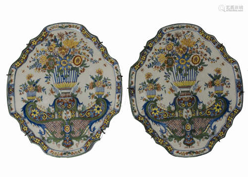 A pair of 18th century Dutch Delft plaques, cartouche-shaped and painted in polychrome with a floral