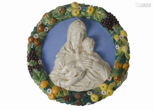 An early 20th Century Della Robbia type majolica roundel, the centre with the virgin and child in