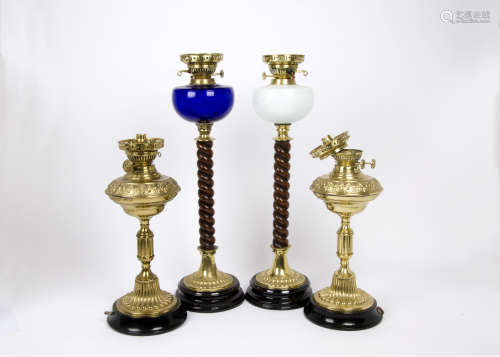 A pair of Victorian converted oil lamps, one with blue glass reservoir, the other with opaque white,