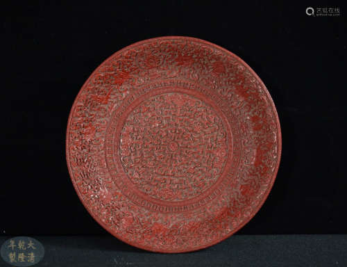 A LACQUER WOOD CARVED FLORAL PATTERN PLATE