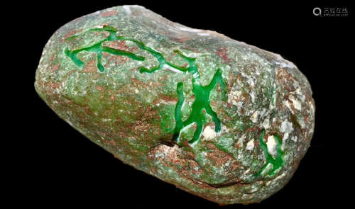 A BURMESE GREEN JADEITE STONE, A CLASS