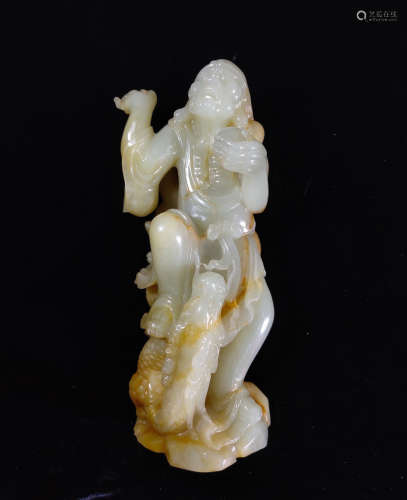 A HETIAN JADE CARVED LUOHAN FIGURE