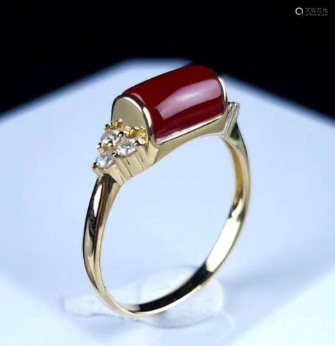 A 18K GOLD WITH RED AK STUD RING