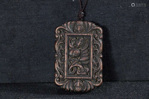 A AGILAWOOD CARVED RELIEVO HANGING TOKEN