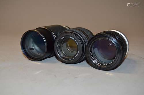 Two Nikon and a Sigma Lenses, a Nikkor-Q Auto 135mm f/2.8 in a bubble case, a Nikon Series E 70-