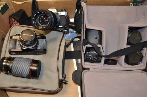 An Olympus OM40 and an Olympus OM10 SLR Cameras, an OM10, chrome, serial no 1724299 with a Zuiko