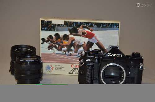 A Canon A1 SLR Body, with maker's box and instructions together with a Canon FD 35-70mm f/3.5-4.5