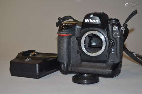 A Nikon D2H DSLR Camera Body, and Charger serial no 2033909, condition G, powers up, shutter
