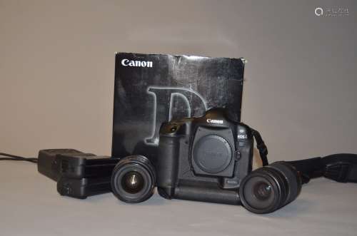 A Canon EOS-1D DSLR Camera and Lenses, serial no 020025, body G, slight wear around flash shoe and