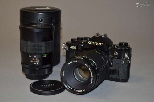 A Canon A1 SLR Camera and two Vivitar Lenses, serial no 1292332, untested, finger grip cover missing