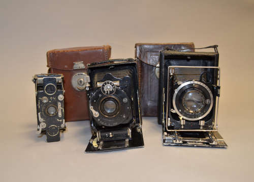 A Group of Three Folding Cameras, a Wallace Heaton New Universal Zodel 6.5 x 9cm folding-bed plate