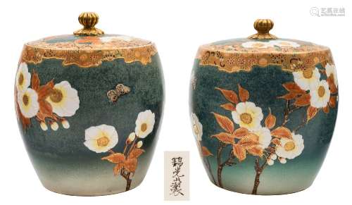 A pair of Satsuma earthenware jars and covers: of barrel shaped form decorated with flowering