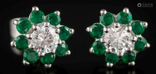 A pair of emerald and diamond mounted circular earrings: each with a central round,