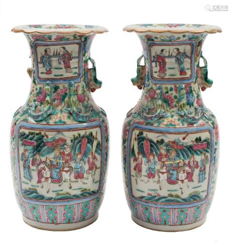 A pair of Canton famille rose baluster vases: the shoulders applied with lion dogs and chilong,