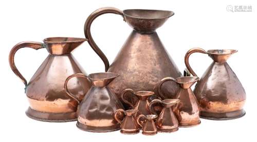 A large 19th century copper measuring jug: together with eight near matching graduated measuring