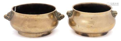 A group of two Chinese polished bronze censers: of compressed globular form with everted rims and