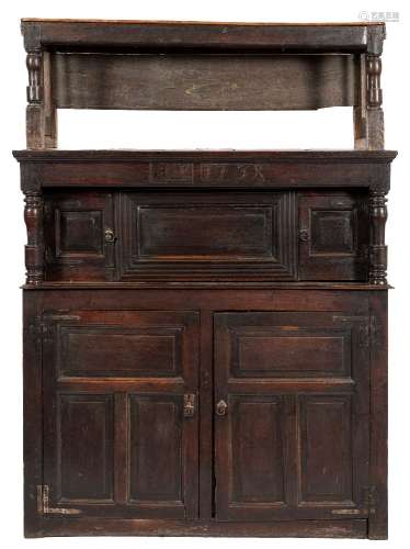 An 18th Century oak tridarn:, with an open and slatted superstructure on turned supports,