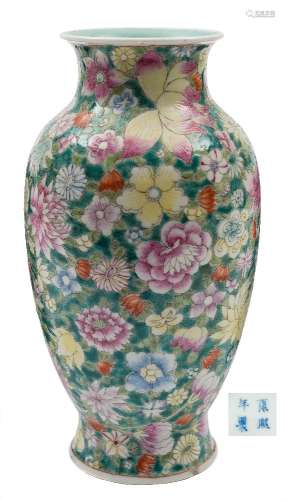 A Chinese famille rose millefleur vase: of baluster form with waisted neck and everted rim,