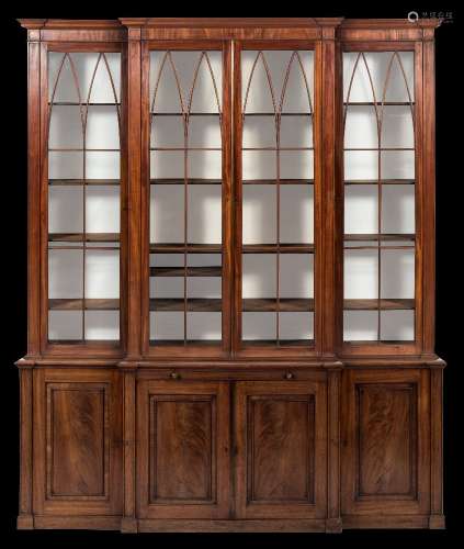 A Regency mahogany breakfront library bookcase:, the upper part with a moulded cornice,