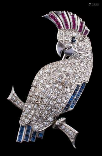 A 20th century diamond, ruby and sapphire 'cockatoo' brooch: pave-set with single-cut diamonds,