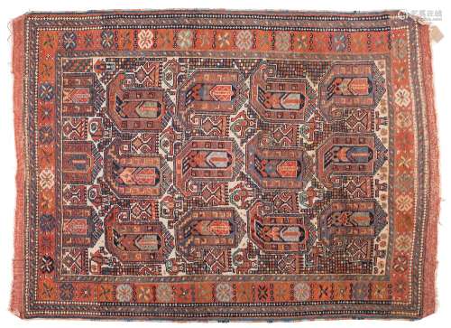 A Quashgai rug:, the beige field with large boteh indigo, pastel blue and rust medallions,