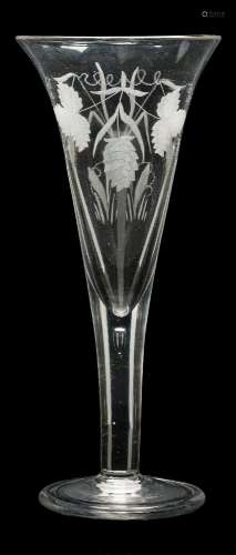 A large ale glass: the trumpet shaped bowl engraved with hops and barley on a straight stem and