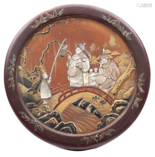 A Japanese lacquered, mother of pearl and ivory inlaid box: of circular outline,