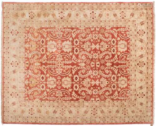 A contemporary Pakistan carpet:, the brick red field with all over geometric foliate design,