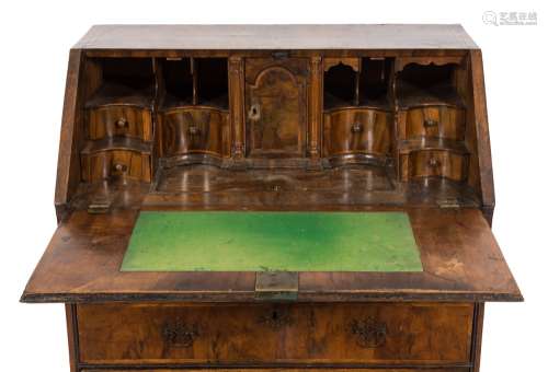 An early 18th Century walnut veneered and cross and feather banded bureau:,