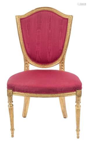 An early 19th Century carved giltwood salon chair in the Hepplewhite taste:,