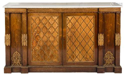 A Regency rosewood, carved giltwood and brass mounted side cabinet:, of breakfront outline,