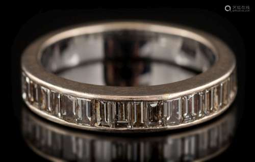 A baguette-cut diamond mounted half-eternity ring: the band channel-set with single row of