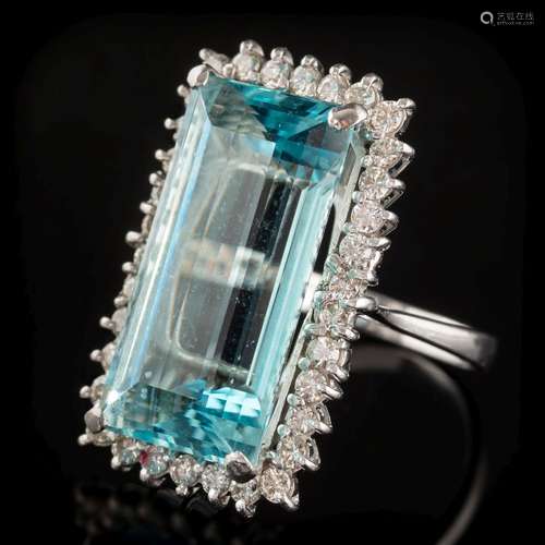 An aquamarine and diamond long rectangular cluster ring: with central step-cut aquamarine 23.