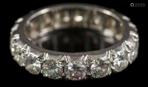 A 20th century diamond eternity ring: pave-set with seventeen round, brilliant-cut diamonds,