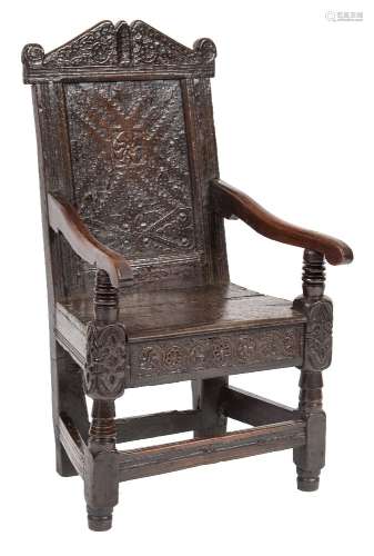 A 17th Century carved oak open armchair:,
