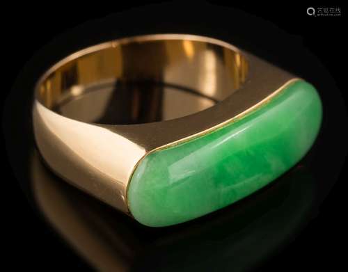 A jade mounted single-stone ring: the oblong polished jade approximately 24mm long x 7.