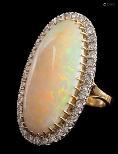 A large opal and diamond oval cluster ring: the central,