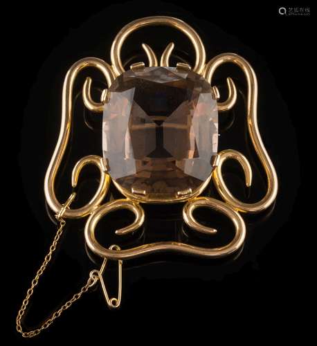 A smoky quartz single-stone brooch: the central,